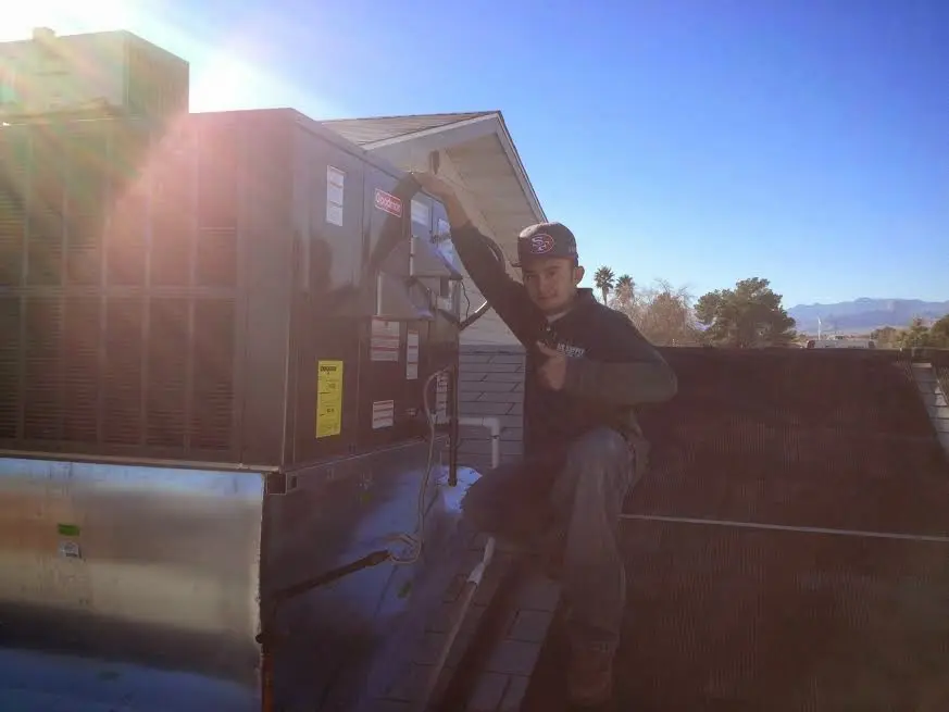 HVAC technician performing Heat Pump Repair on a rooftop unit in Ukiah